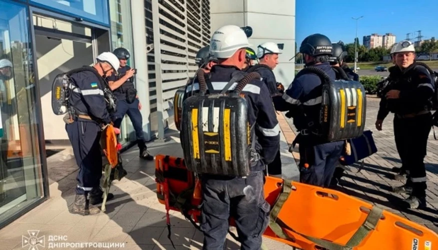 Пошкоджена будівля найбільшого ТЦ Кривого Рогу після удару безпілотниками, пожежа всередині, рятувальні служби на місці.